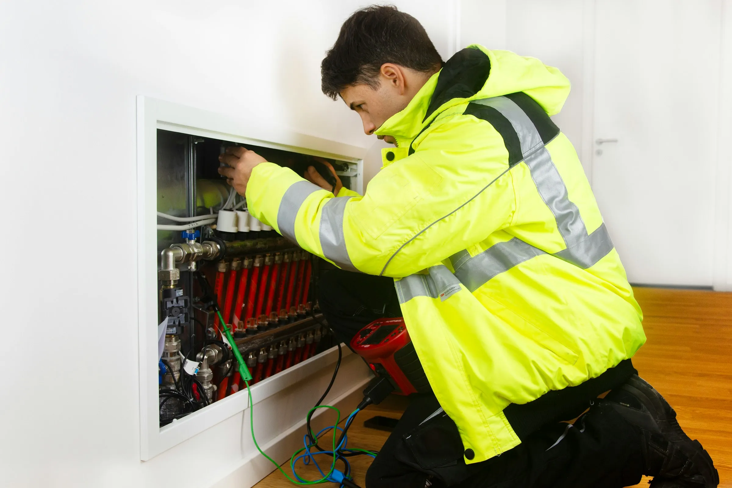 An HVAC technician in the truck checking the day's jobs on a phone